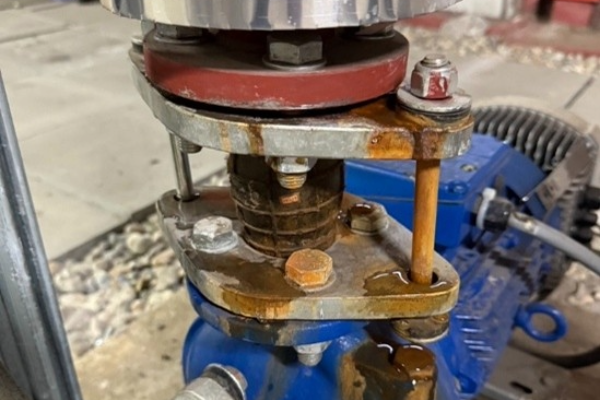 A circulation heat pump with rust around the bolts due to poor water quality.