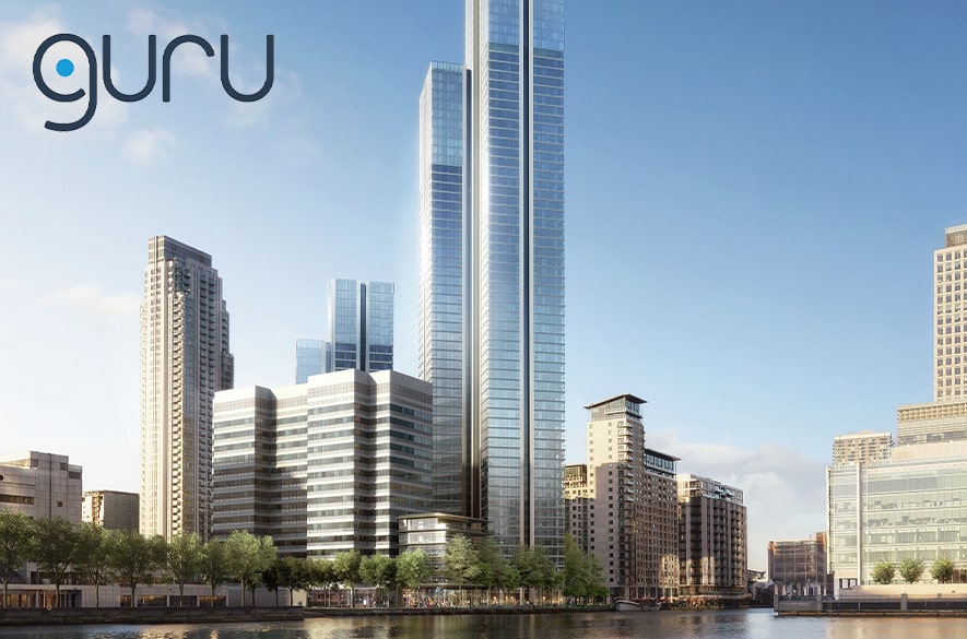 Computer‑generated image of the South Quay Plaza residential development, showing tall glass‑clad tower buildings rising above lower surrounding blocks beside a dockside waterway. Trees line the waterfront at ground level, with the Canary Wharf skyline visible in the background. A “Guru” logo appears in the top‑left corner of the image.