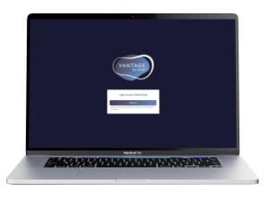 A laptop with the VANTAGE log in screen displayed.