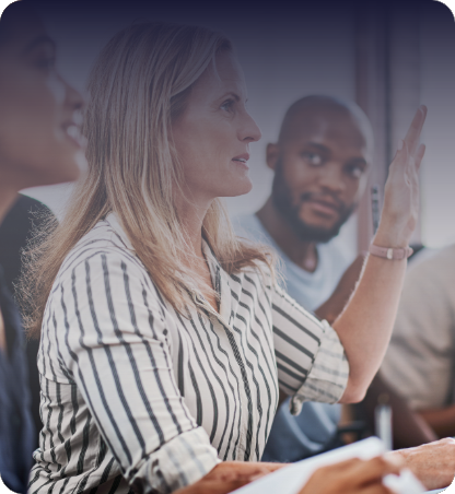 Woman raises hand to ask a question in a CPD certified seminar.