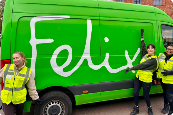 Three Insite employees in high0vis jackets are stood in front of a green, Felix-branded delivery van.